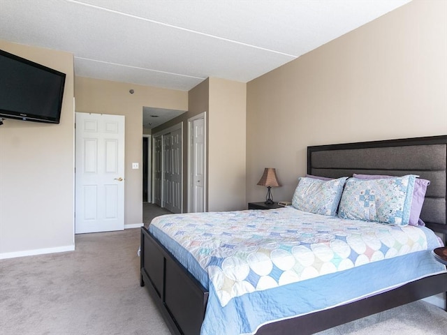 bedroom with carpet floors and baseboards