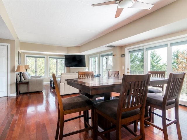 dining space with plenty of natural light, hardwood / wood-style flooring, ceiling fan, and visible vents