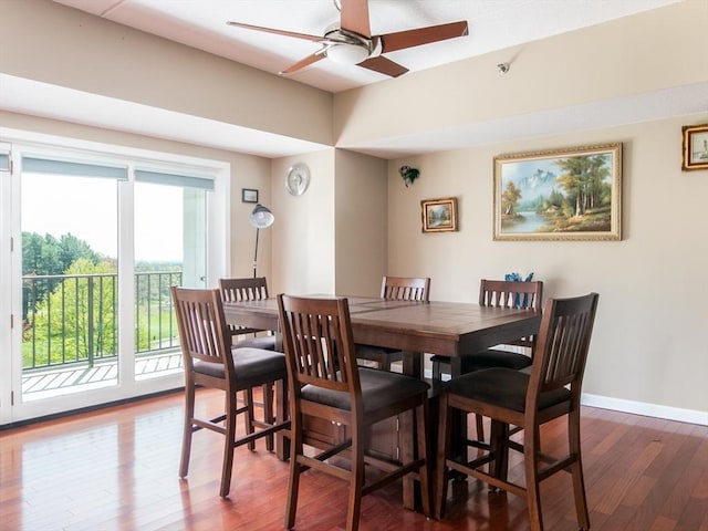 dining area featuring a ceiling fan, baseboards, and wood finished floors