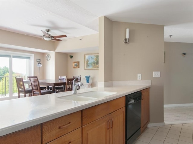 kitchen with dishwasher, ceiling fan, light countertops, a sink, and light tile patterned floors