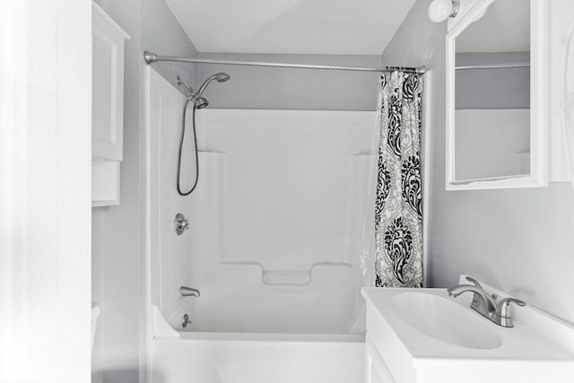 bathroom featuring shower / bath combo and vanity