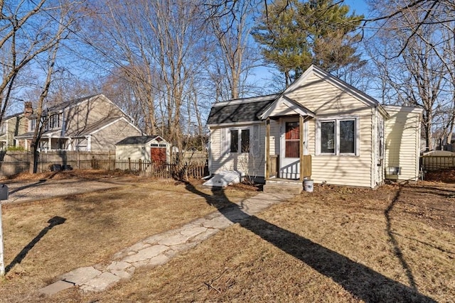 bungalow-style house featuring entry steps and fence