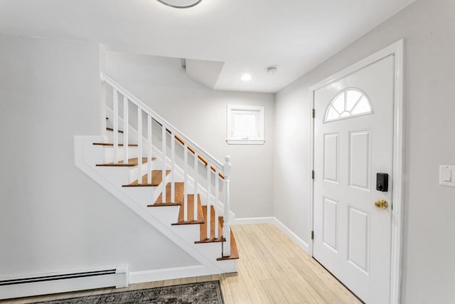 foyer featuring a baseboard radiator, stairway, light wood finished floors, recessed lighting, and baseboards