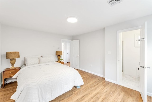 bedroom featuring light wood-style floors and baseboards