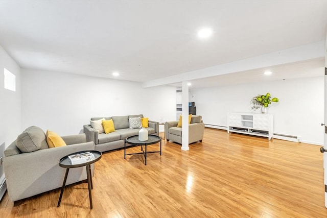 living area featuring light wood finished floors, recessed lighting, and baseboard heating