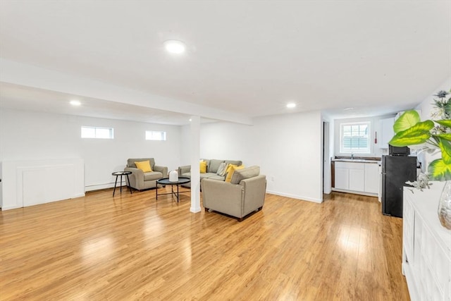living room with light wood-style flooring and recessed lighting