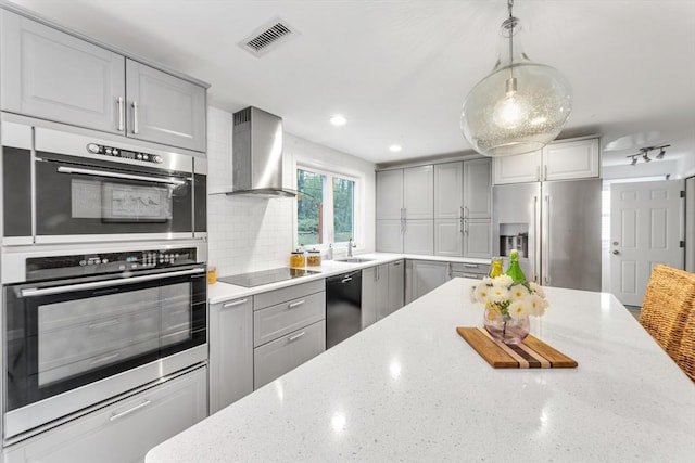 kitchen with black appliances, gray cabinetry, wall chimney exhaust hood, a sink, and recessed lighting
