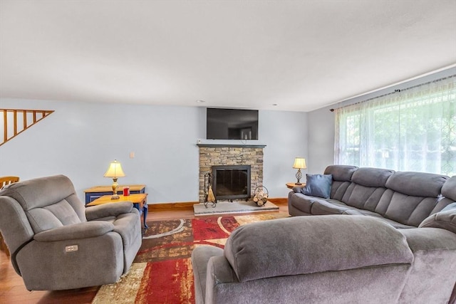 98 Town Farm Rd, Monson, MA 01057 - living room with wood finished floors, stairs, a stone fireplace, and baseboards