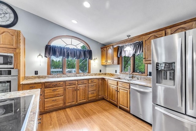 98 Town Farm Rd, Monson, MA 01057 - kitchen with appliances with stainless steel finishes, vaulted ceiling, a sink, light stone countertops, and brown cabinets