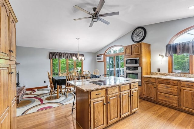 98 Town Farm Rd, Monson, MA 01057 - kitchen with oven, built in microwave, light wood-style floors, vaulted ceiling, and a kitchen bar