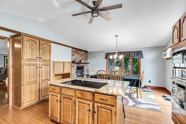 98 Town Farm Rd, Monson, MA 01057 - kitchen featuring appliances with stainless steel finishes, a fireplace, a ceiling fan, plenty of natural light, and vaulted ceiling