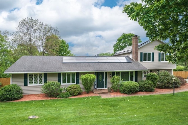 98 Town Farm Rd, Monson, MA 01057 - traditional home featuring roof mounted solar panels, a shingled roof, and a chimney