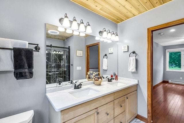 98 Town Farm Rd, Monson, MA 01057 - bathroom with baseboard heating, double vanity, toilet, and baseboards