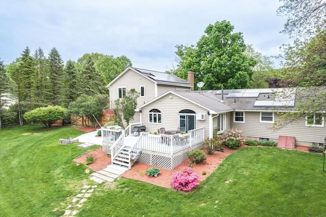 98 Town Farm Rd, Monson, MA 01057 - rear view of property featuring a deck, a yard, a shingled roof, and solar panels