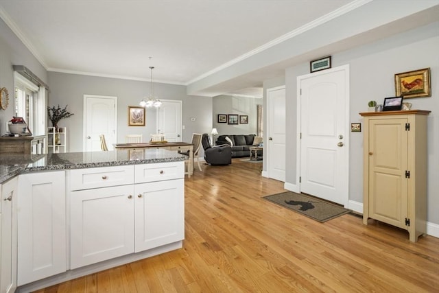 5 Mackenzie Way Unit 5, Haverhill, MA 01832 - kitchen featuring dark stone countertops, white cabinetry, light wood-style floors, a chandelier, and crown molding