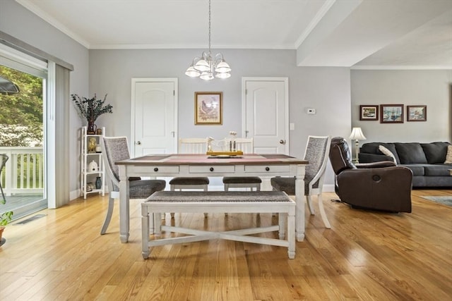 5 Mackenzie Way Unit 5, Haverhill, MA 01832 - dining space with light wood-style flooring, a chandelier, and crown molding