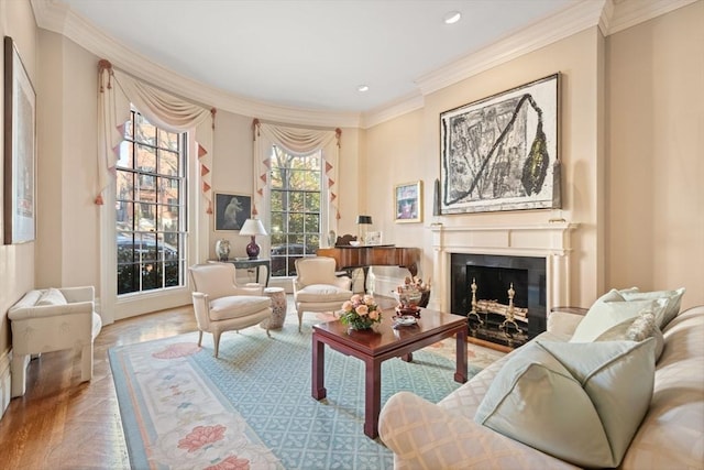 sitting room with ornamental molding and light parquet flooring