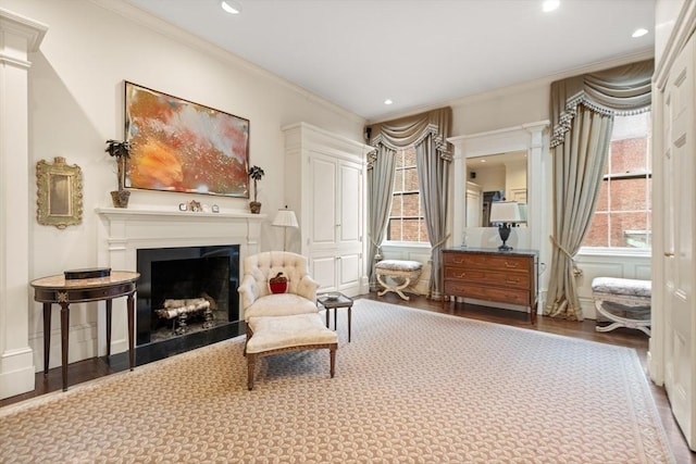 sitting room featuring hardwood / wood-style floors and ornamental molding