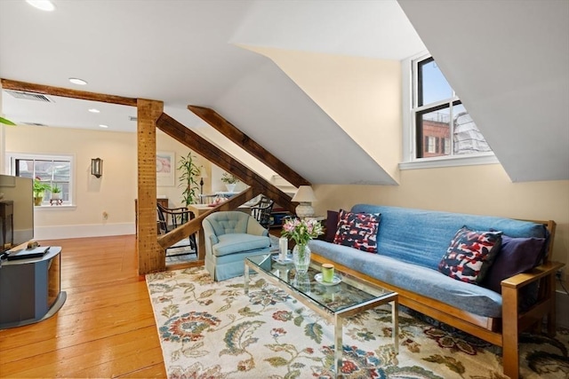 living room featuring hardwood / wood-style floors and vaulted ceiling