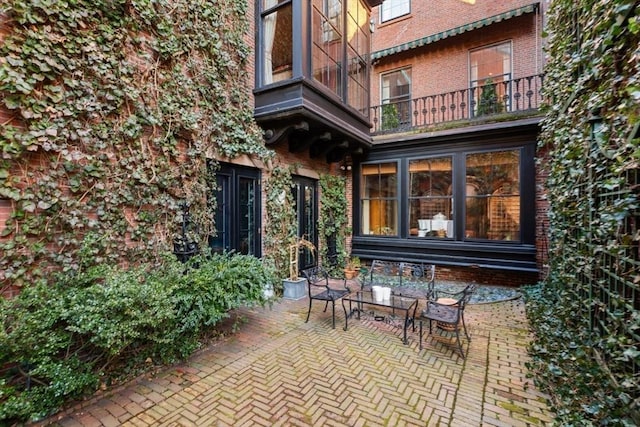 view of patio featuring a balcony