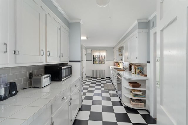 kitchen with black microwave, dark floors, white cabinetry, radiator, and open shelves