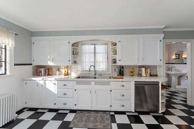 kitchen featuring radiator heating unit, dark floors, stainless steel dishwasher, open shelves, and a sink