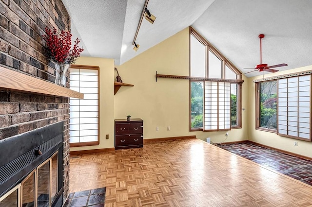236 Williamsburg Dr, Longmeadow, MA 01106 - unfurnished living room featuring a textured ceiling, lofted ceiling, baseboards, ceiling fan, and a brick fireplace