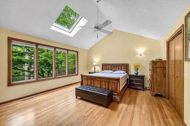 236 Williamsburg Dr, Longmeadow, MA 01106 - bedroom with a skylight, lofted ceiling, light wood-style flooring, a ceiling fan, and baseboards