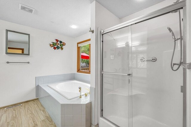 236 Williamsburg Dr, Longmeadow, MA 01106 - bathroom with wood finished floors, a garden tub, a shower stall, and baseboards