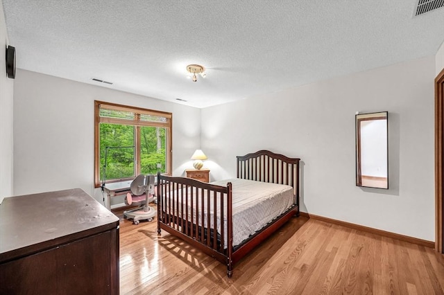 236 Williamsburg Dr, Longmeadow, MA 01106 - bedroom featuring light wood-style flooring, a textured ceiling, and baseboards