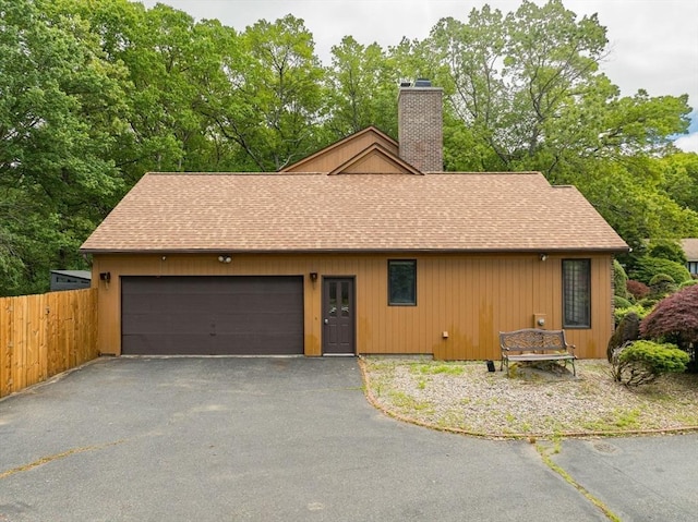 236 Williamsburg Dr, Longmeadow, MA 01106 - view of front of property with a shingled roof, a chimney, asphalt driveway, and a garage