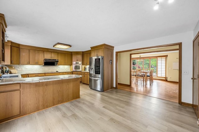 236 Williamsburg Dr, Longmeadow, MA 01106 - kitchen featuring stainless steel appliances, range hood, a sink, a peninsula, and brown cabinets