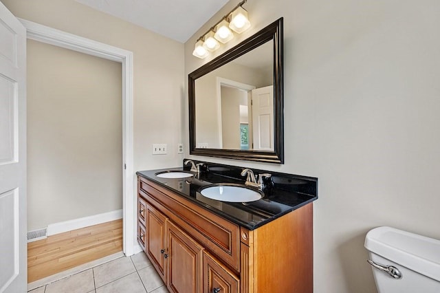 21 Nourse St, Westborough, MA 01581 - bathroom featuring toilet, double vanity, tile patterned floors, and baseboards