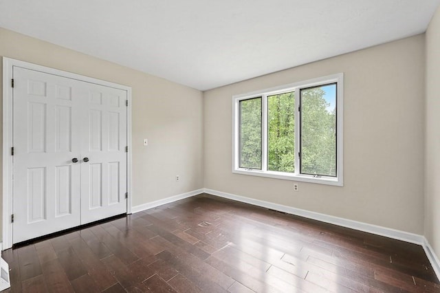 21 Nourse St, Westborough, MA 01581 - unfurnished bedroom featuring baseboards, dark wood-style flooring, and a closet