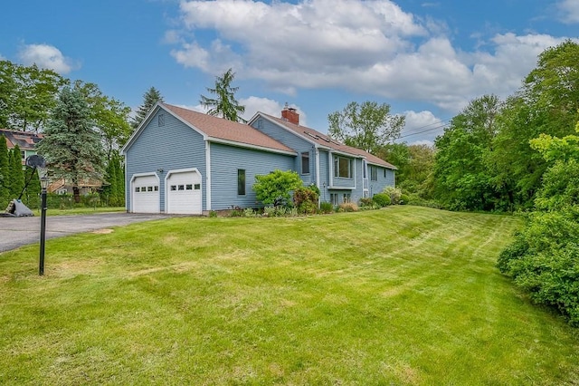 21 Nourse St, Westborough, MA 01581 - view of home's exterior with asphalt driveway, a chimney, and a lawn