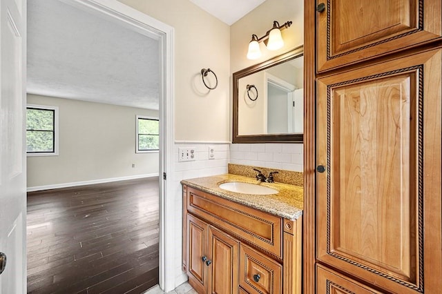 21 Nourse St, Westborough, MA 01581 - bathroom featuring wood-type flooring, vanity, healthy amount of natural light, and baseboards