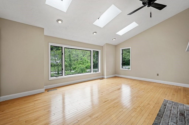 21 Nourse St, Westborough, MA 01581 - unfurnished room featuring a skylight, healthy amount of natural light, wood-type flooring, baseboards, and lofted ceiling