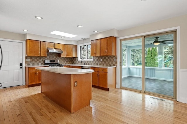 21 Nourse St, Westborough, MA 01581 - kitchen featuring under cabinet range hood, stainless steel range oven, a sink, brown cabinetry, and recessed lighting