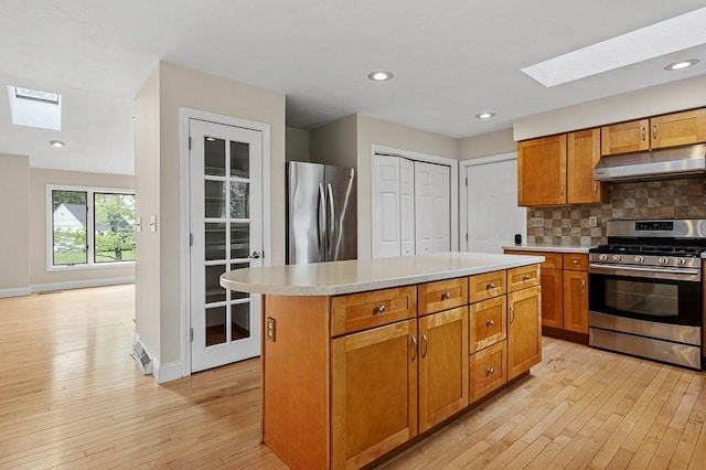 21 Nourse St, Westborough, MA 01581 - kitchen featuring a skylight, appliances with stainless steel finishes, under cabinet range hood, light wood-style flooring, and recessed lighting