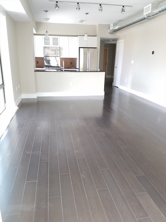 unfurnished living room with dark hardwood / wood-style floors