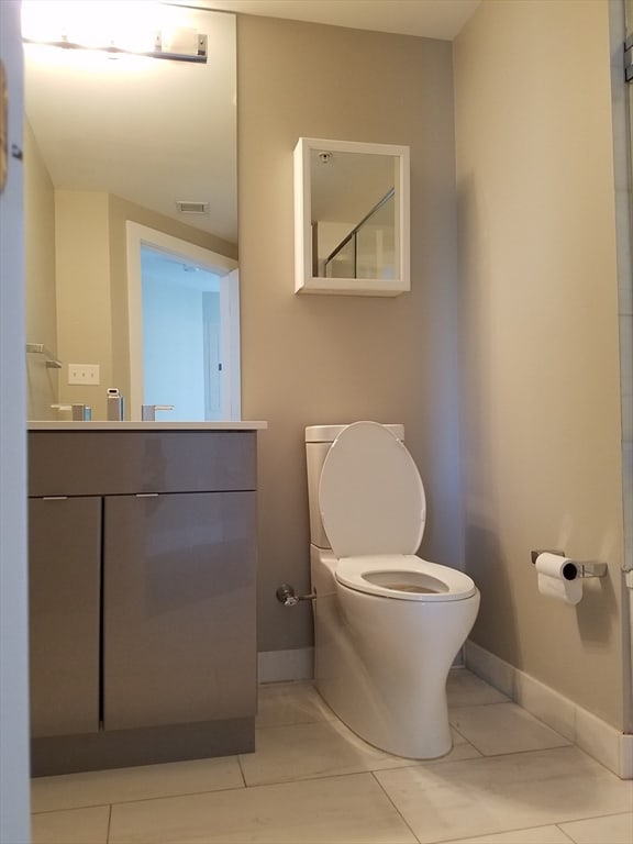 bathroom with tile patterned floors, vanity, and toilet