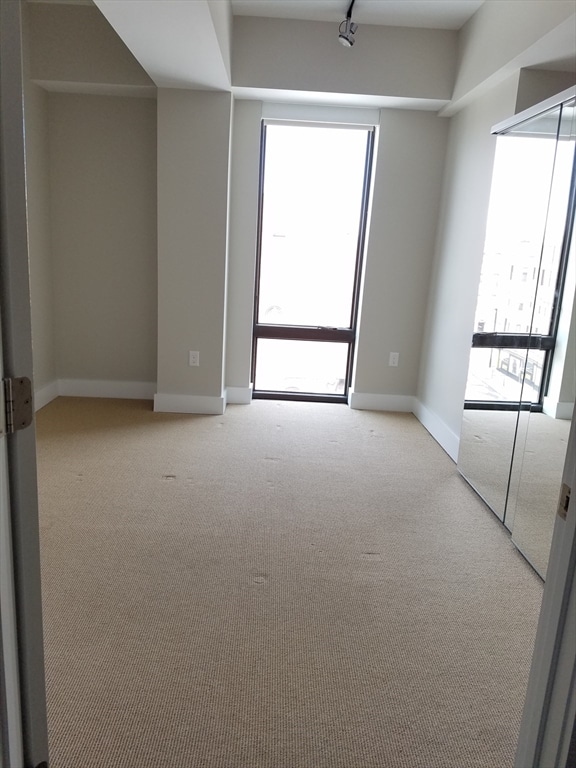 empty room with light colored carpet