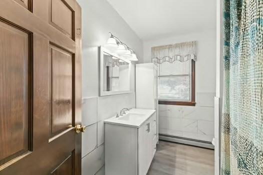 120 Hatchfield Dr, Brockton, MA 02301 - full bathroom featuring baseboard heating, vanity, and wood finished floors