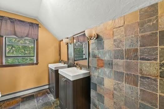 120 Hatchfield Dr, Brockton, MA 02301 - full bath with a baseboard heating unit, lofted ceiling, two vanities, and stone finish floors
