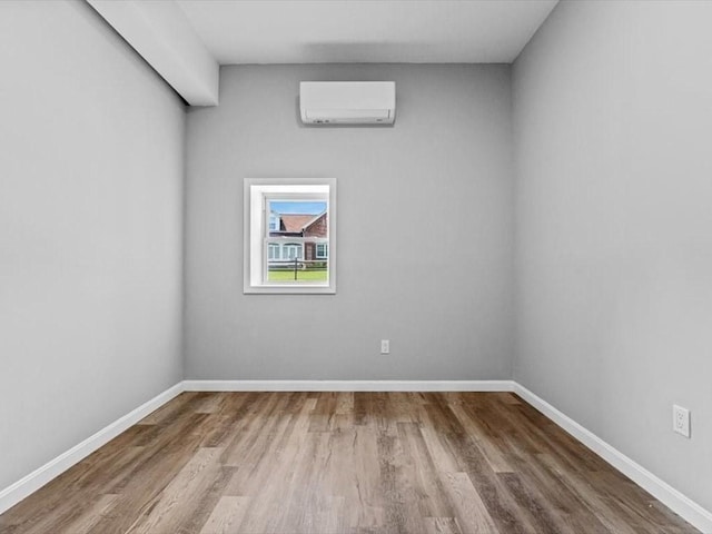 273 Elm St, Southbridge, MA 01550 - empty room with a wall unit AC and wood finished floors
