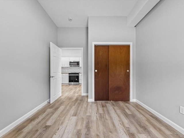 273 Elm St, Southbridge, MA 01550 - unfurnished living room featuring light wood-style flooring and baseboards