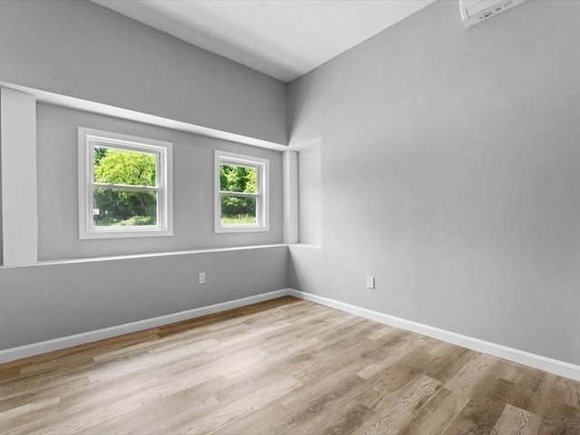 273 Elm St, Southbridge, MA 01550 - unfurnished room with light wood finished floors and a wall unit AC