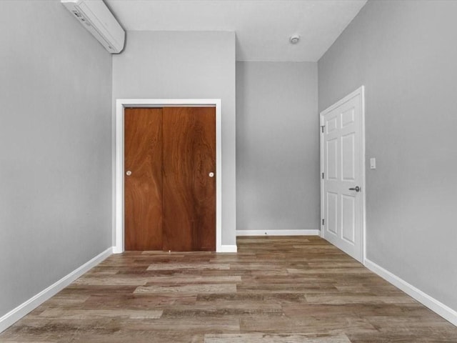 273 Elm St, Southbridge, MA 01550 - spare room with a wall mounted AC, wood finished floors, and a smoke detector