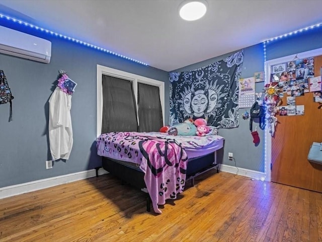 273 Elm St, Southbridge, MA 01550 - bedroom featuring an AC wall unit and wood finished floors
