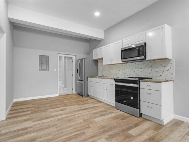 273 Elm St, Southbridge, MA 01550 - kitchen with stainless steel appliances, decorative backsplash, white cabinets, electric panel, and recessed lighting